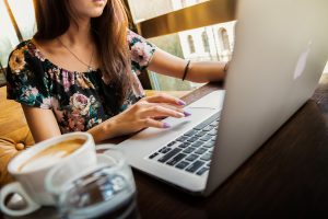 Woman at computer with a cup of coffee
