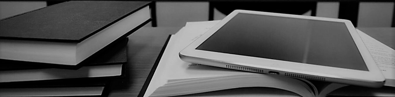 books and an ipad sitting on a desk